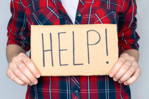 Person Holding Help Sign
