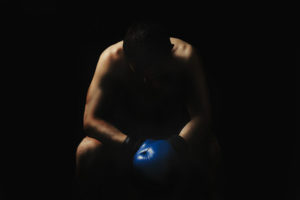 Boxer Sitting Against Dark Background