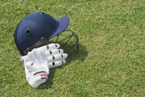 Cricket Helmet and Glove on Field