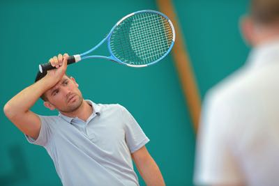 Man upset playing tennis