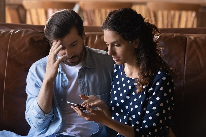 Concerned Couple Looking at Phone