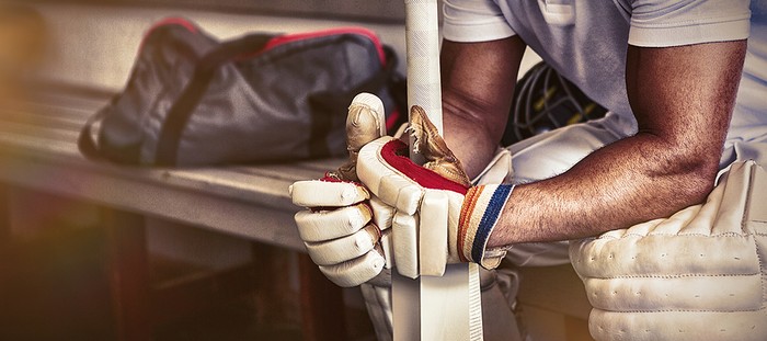 Cricket Player Sitting in Changing Room