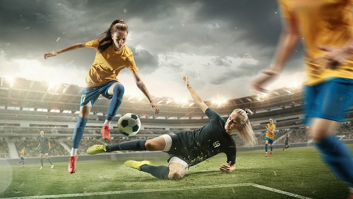 Female Footballer Sliding Tackle