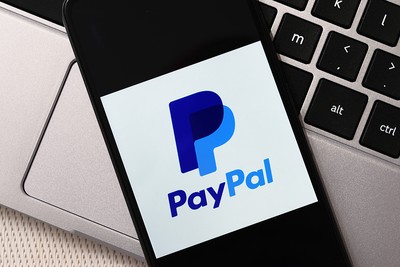 PayPal Logo on Smartphone on Top of Laptop