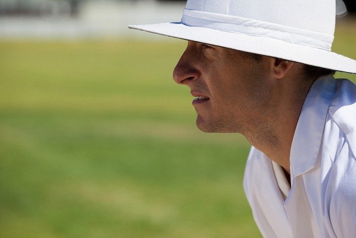 Side View of Cricket Umpire Watching Game