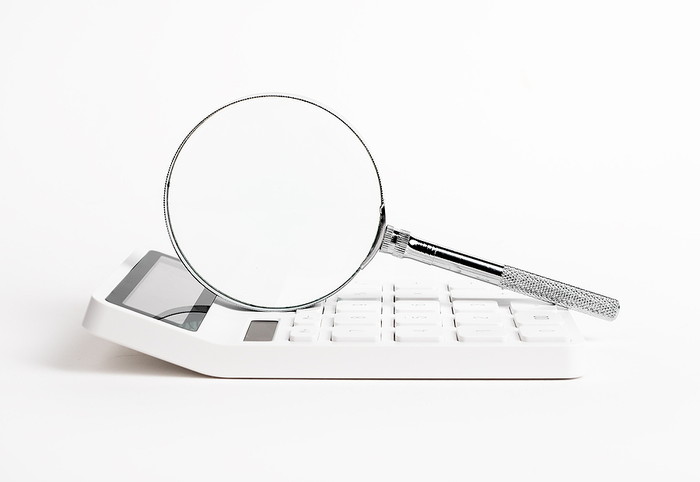 Magnifying Glass and White Calculator
