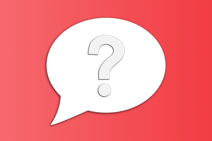 White Question Mark Speech Bubble Against Red Background