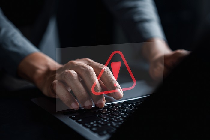 Holographic Warning Triangle on Laptop